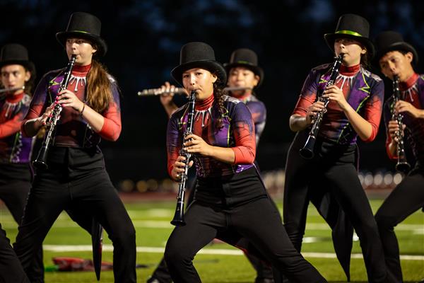 Ravenwood High band members march